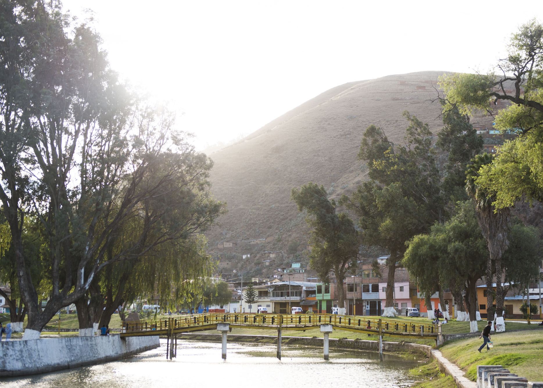 River with a bridge and mountainside in Huanuco